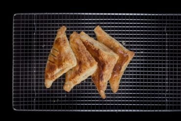 Easy Apple Turnovers Recipe - make these with only 4 ingredientsEasy Apple Turnovers Recipe (Only 4 Ingredients & 10-mins prep)! Flaky & crisp buttery puff pastry, bursting with warm cinnamon-spiced applesauce. Perfect Autumn desserts.