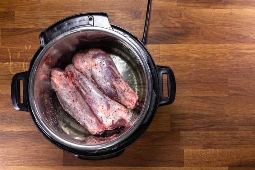 Pressure Cooker Lamb Shanks: brown seasoned lamb shanks in Instant Pot Pressure Cooker